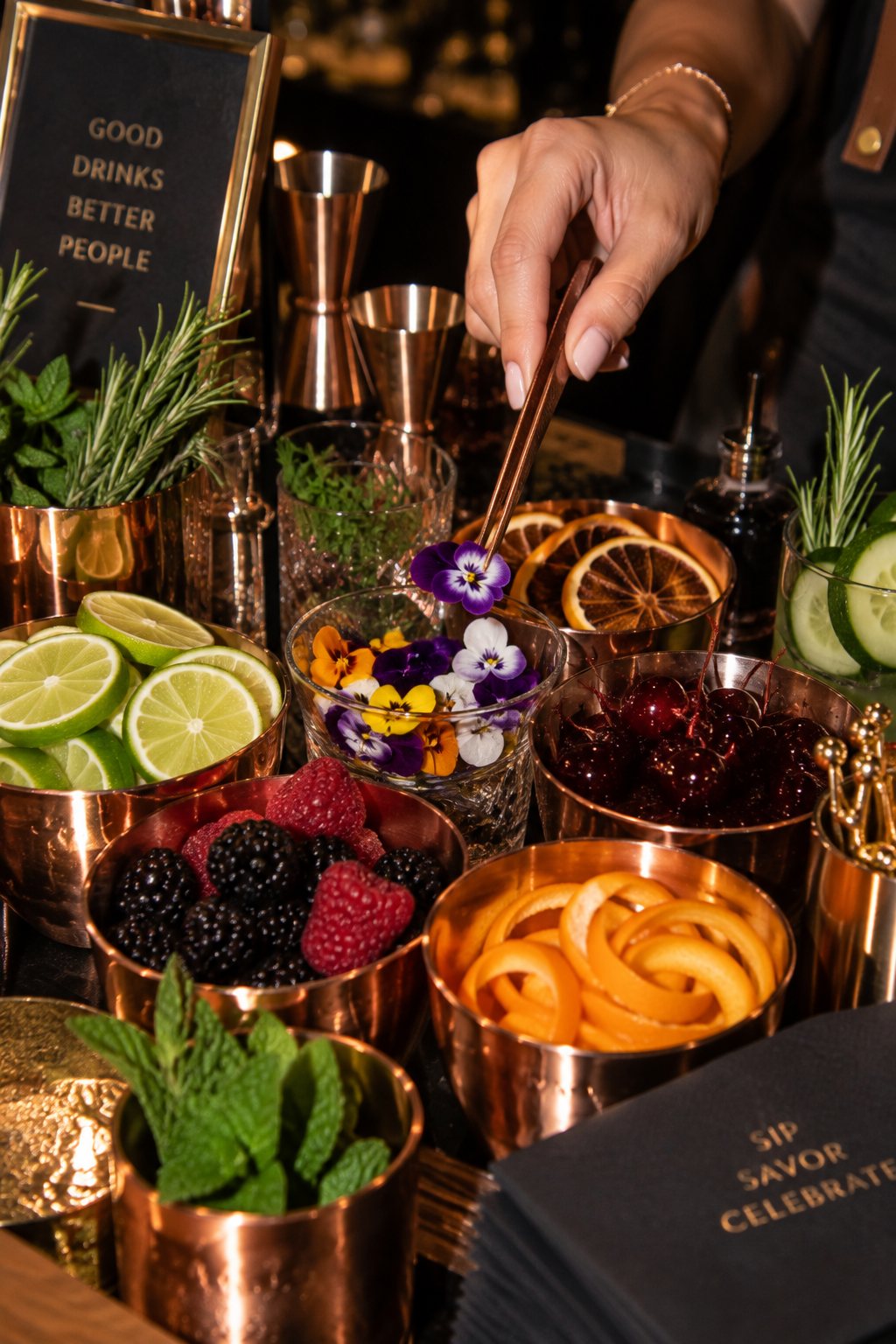 Cocktail garnish station with citrus, berries and fresh herbs