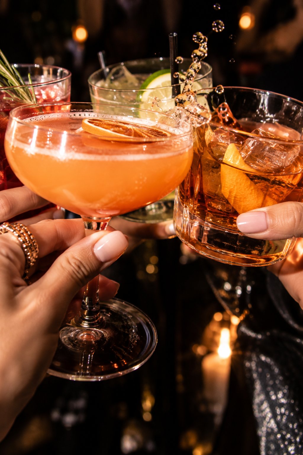 Cocktail glasses clinking in a toast